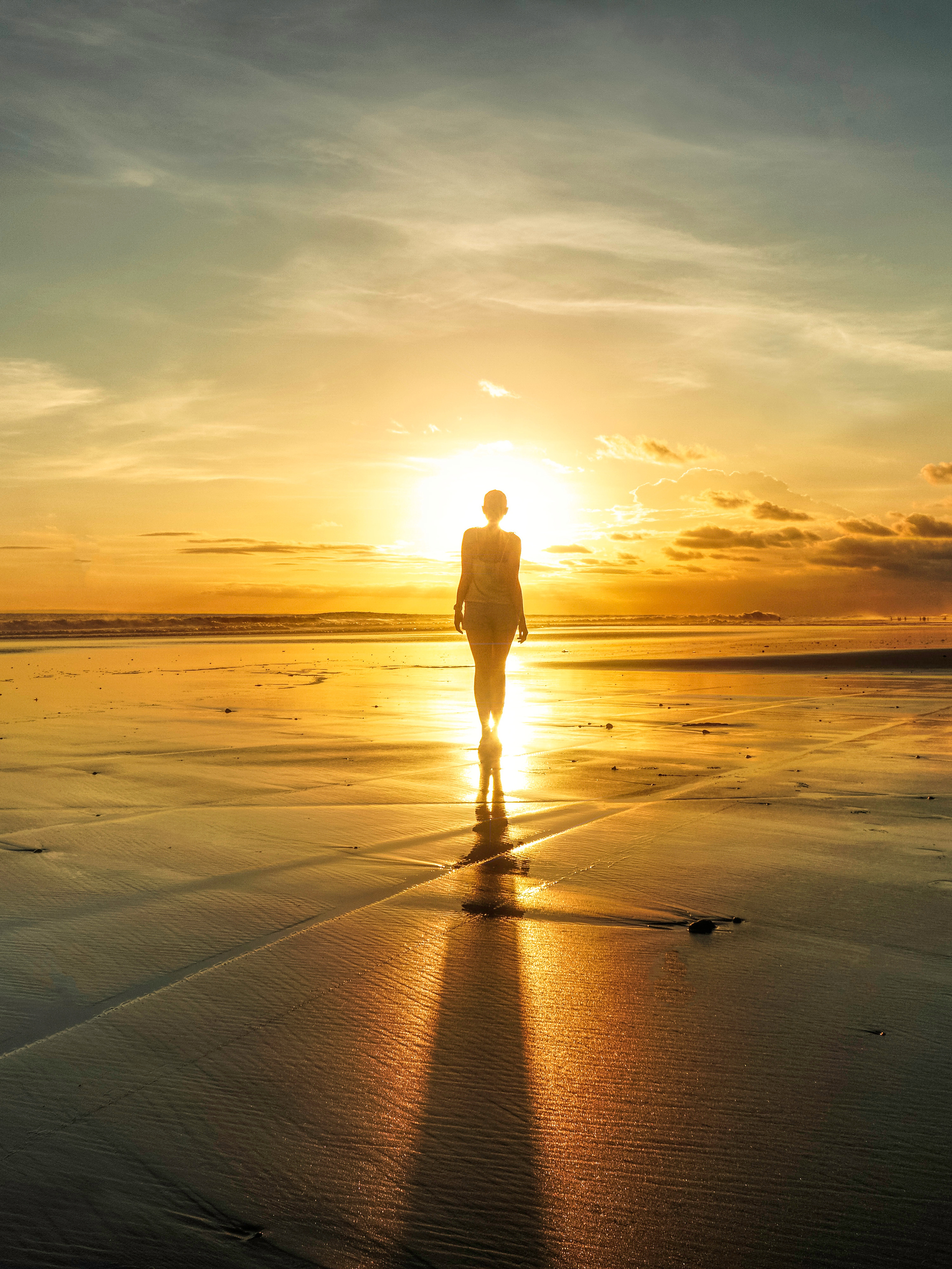 Silhouette Of Woman Standing On Seashore